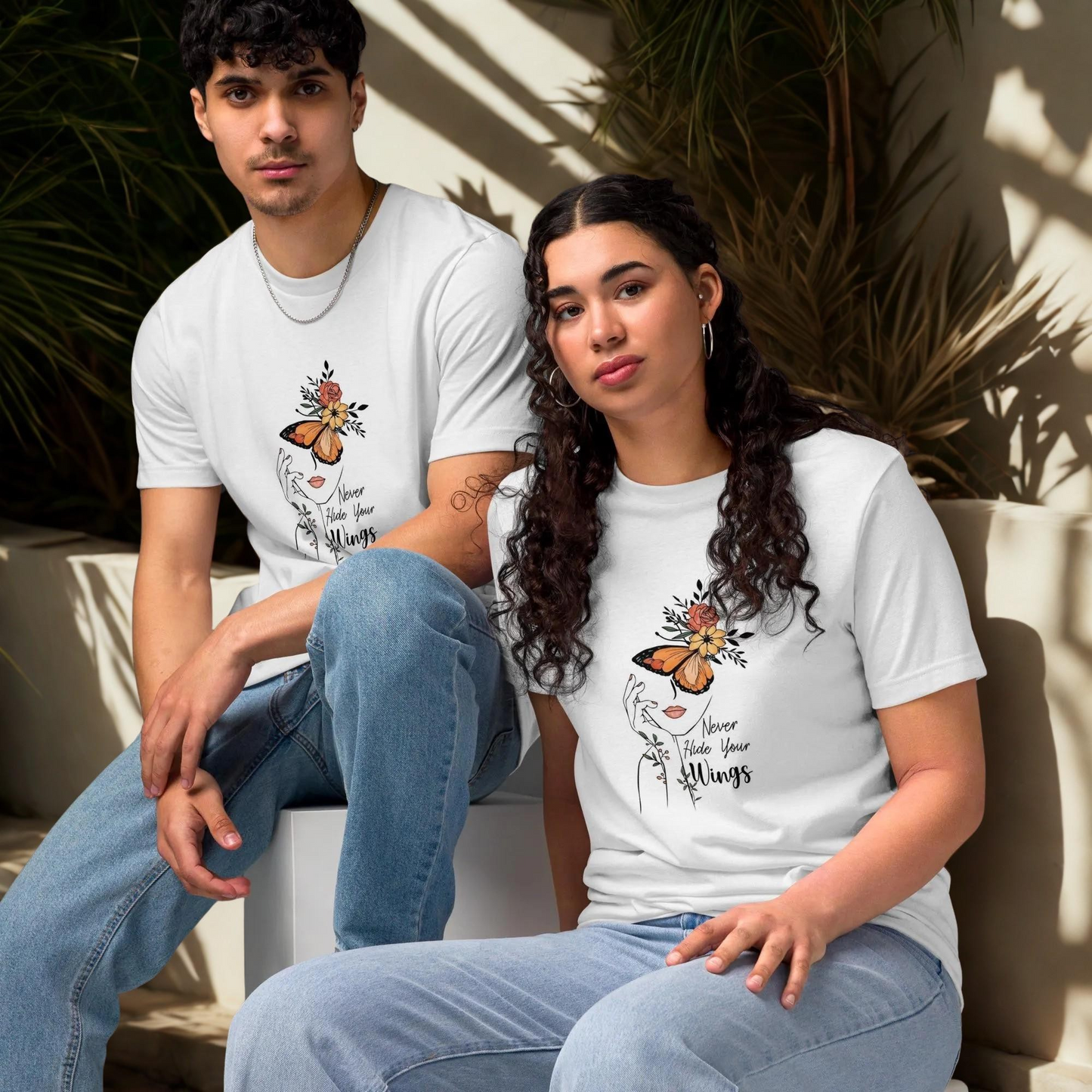 Unisex white Butterfly Graphic Organic Cotton T Shirt with nature-inspired design, worn by male and female models sitting indoors