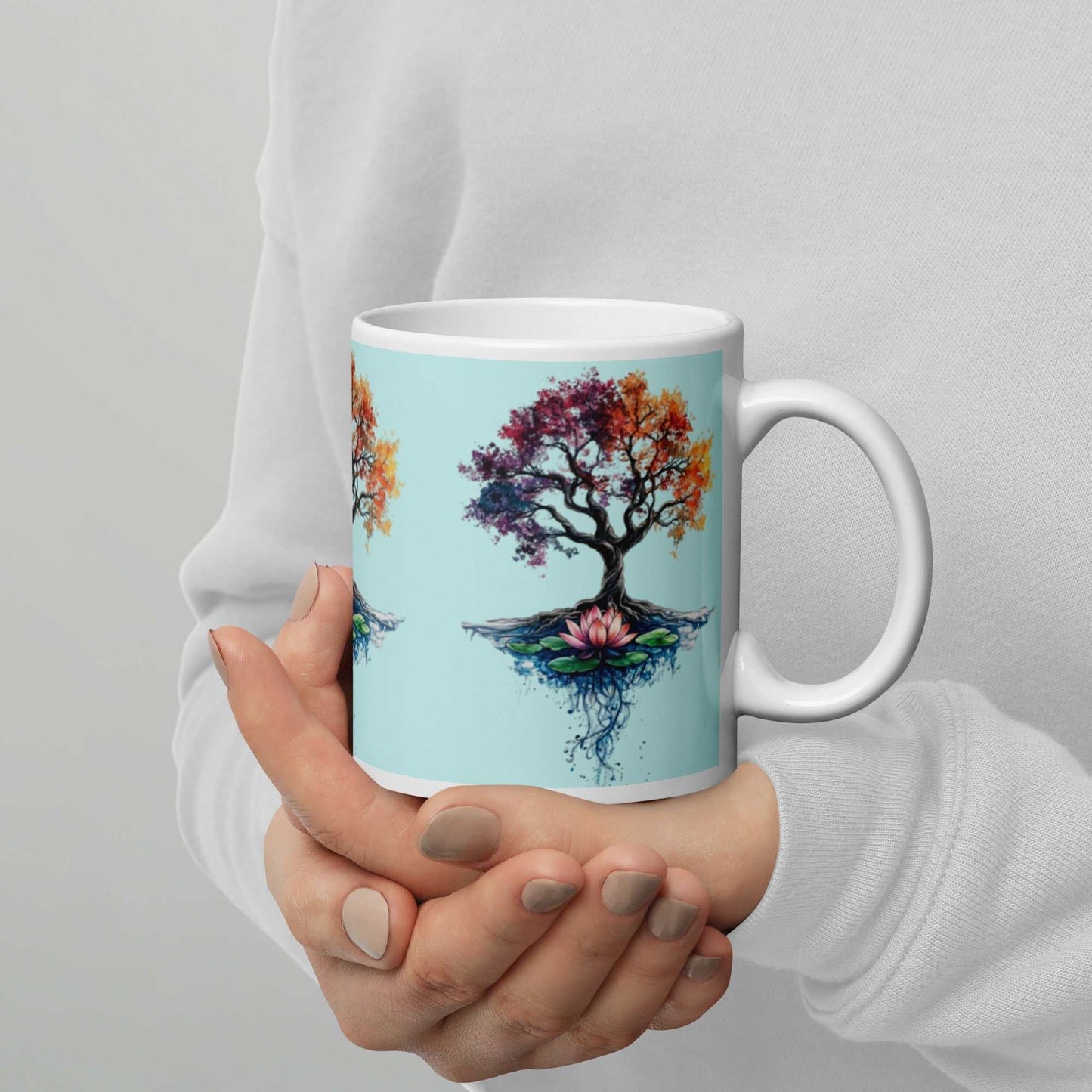 White Glossy Mug with colorful Tree of Life Energy Artwork held in hands against light background