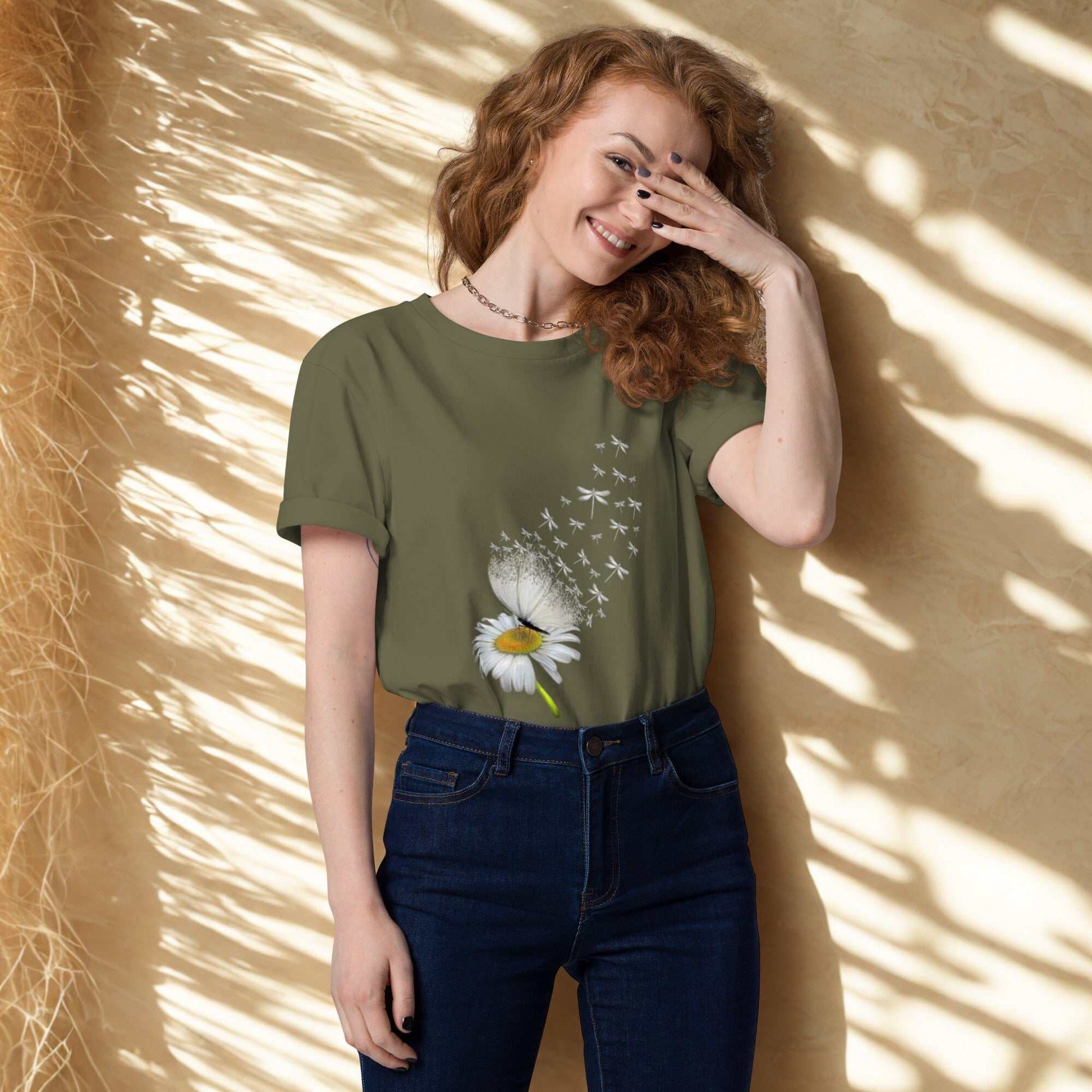 Woman wearing Bloom & Fly Mystic Daisy Organic Cotton Tee with daisy and butterfly design in olive green
