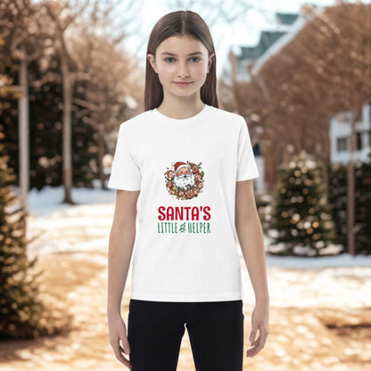 Child wearing white Santa's Little Helper Christmas T-Shirt with festive design outdoors in winter setting
