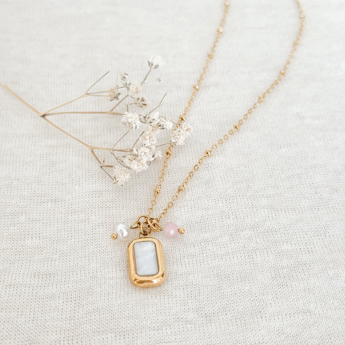 Gold-plated stainless steel necklace with shell inlay, freshwater pearl, and lavender jade charm.