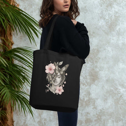 Black Eco Tote Bag with a floral and butterfly design, carried by a woman, eco-friendly and spacious reusable shopping bag