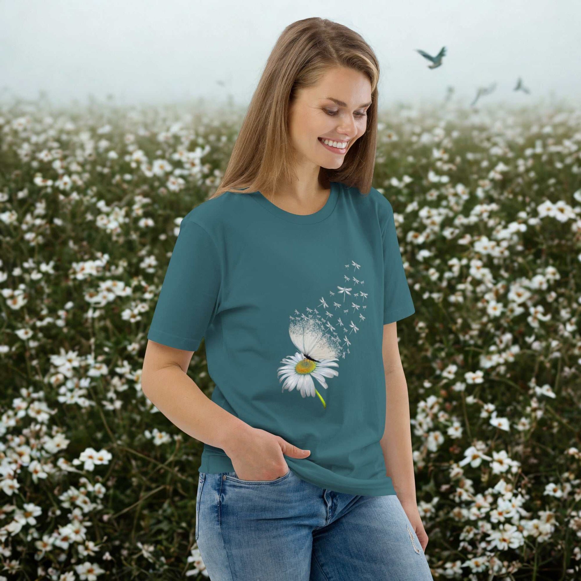 Woman wearing Bloom & Fly Mystic Daisy Organic Cotton Tee with daisy graphic in a flower field