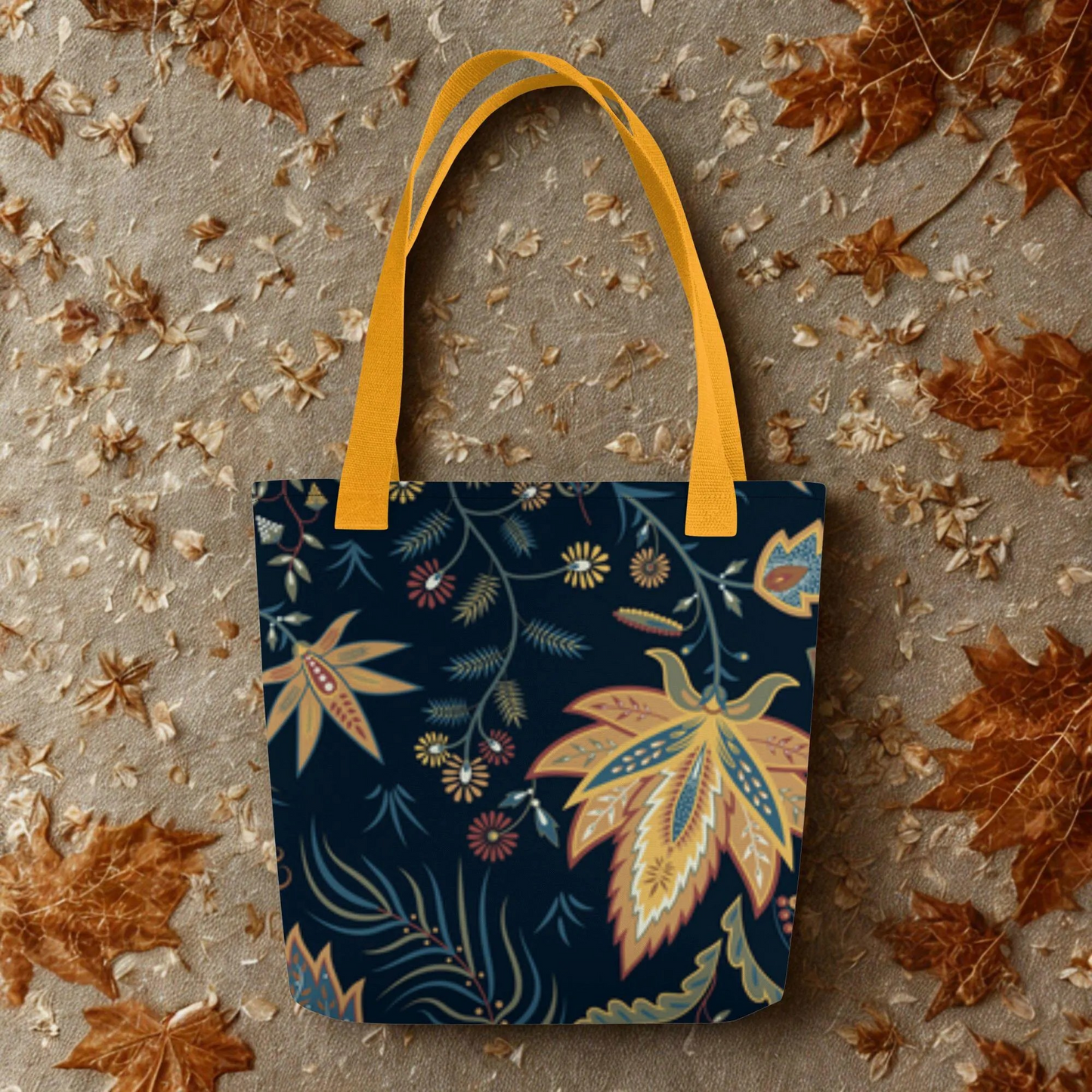 Autumn Floral Tote Bag with warm leaf design and yellow handles on fall leaf background