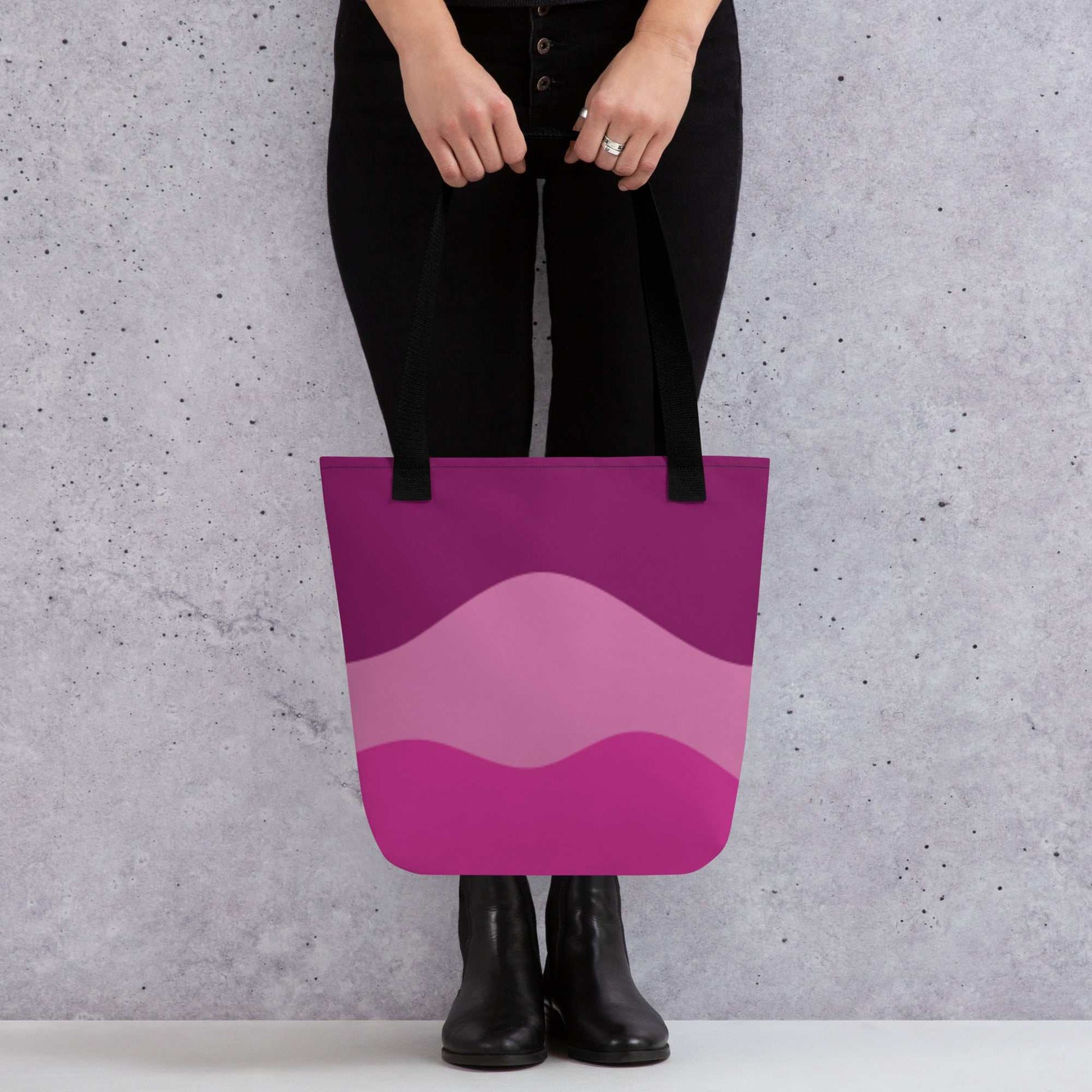 Mystic Butterfly Tote Bag with purple and pink wave design held by person wearing black pants and boots