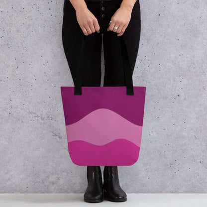 Mystic Butterfly Tote Bag with purple and pink wave design held by person wearing black pants and boots