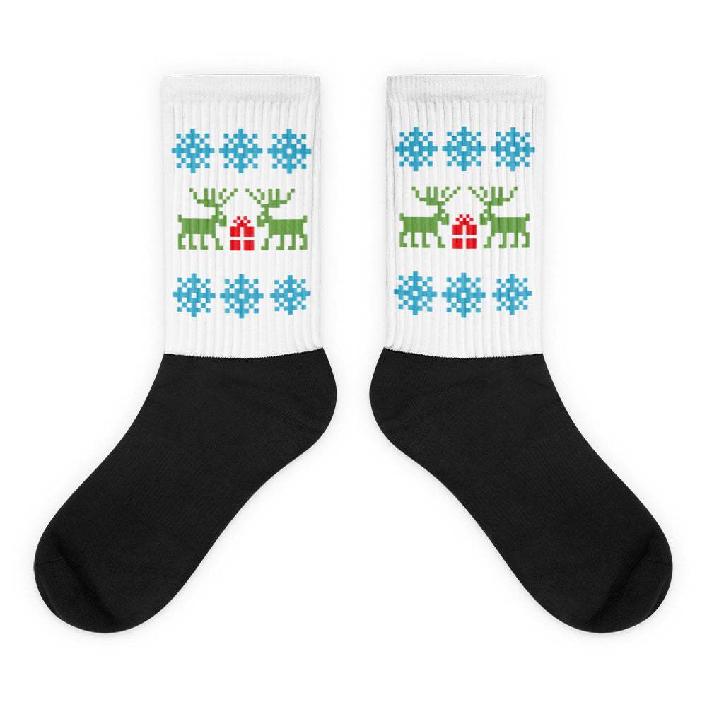 Black and white socks with Christmas reindeer and blue snowflake pattern, ribbed crew length, unisex holiday design