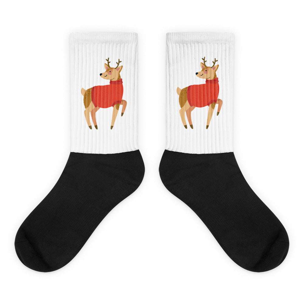 White and black crew socks featuring a Christmas reindeer illustration and rib knit texture, made from a soft cotton blend with stretch for comfort.