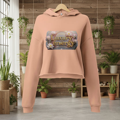Luxury is My Energy Cropped Hoodie in blush pink with floral logo print, soft cotton blend, and raw hem design