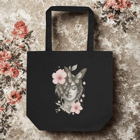Black eco tote bag with artistic butterfly and flower design made from organic cotton