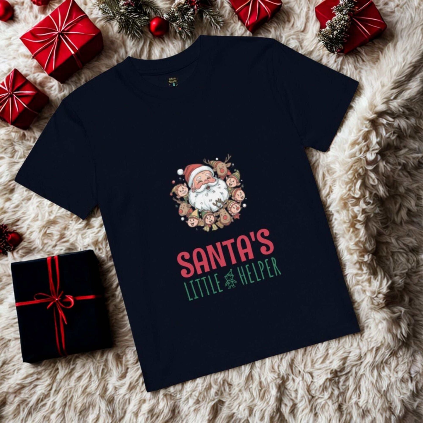 Navy Santa's Little Helper Christmas T-Shirt with Santa and reindeer design surrounded by wrapped gifts on a fuzzy surface