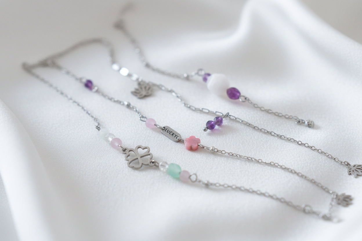 “Detail van geluksarmbandje met Lucky bedel en edelstenen”