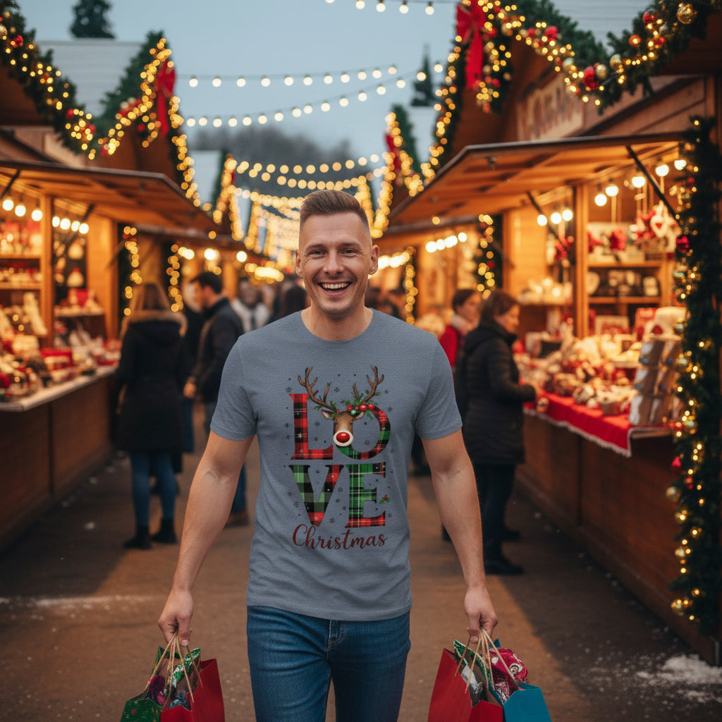 Man wearing organic cotton Christmas t-shirt with festive "LOVE Christmas" reindeer print in a cozy indoor setting