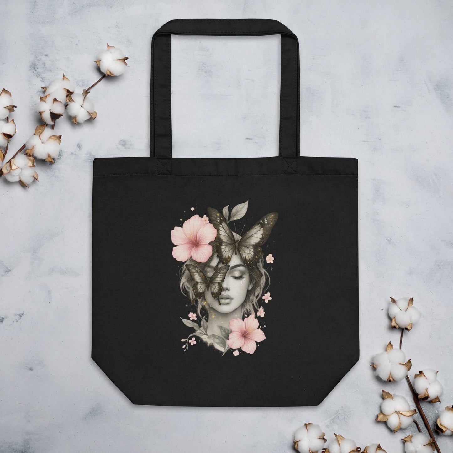 Black Eco Tote Bag with artistic woman, butterfly, and flower design, made of organic cotton, durable and spacious for daily use