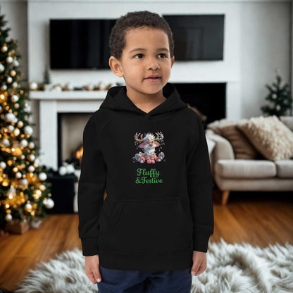 Child wearing black kids Christmas hoodie with festive cat design standing in cozy living room decorated for Christmas