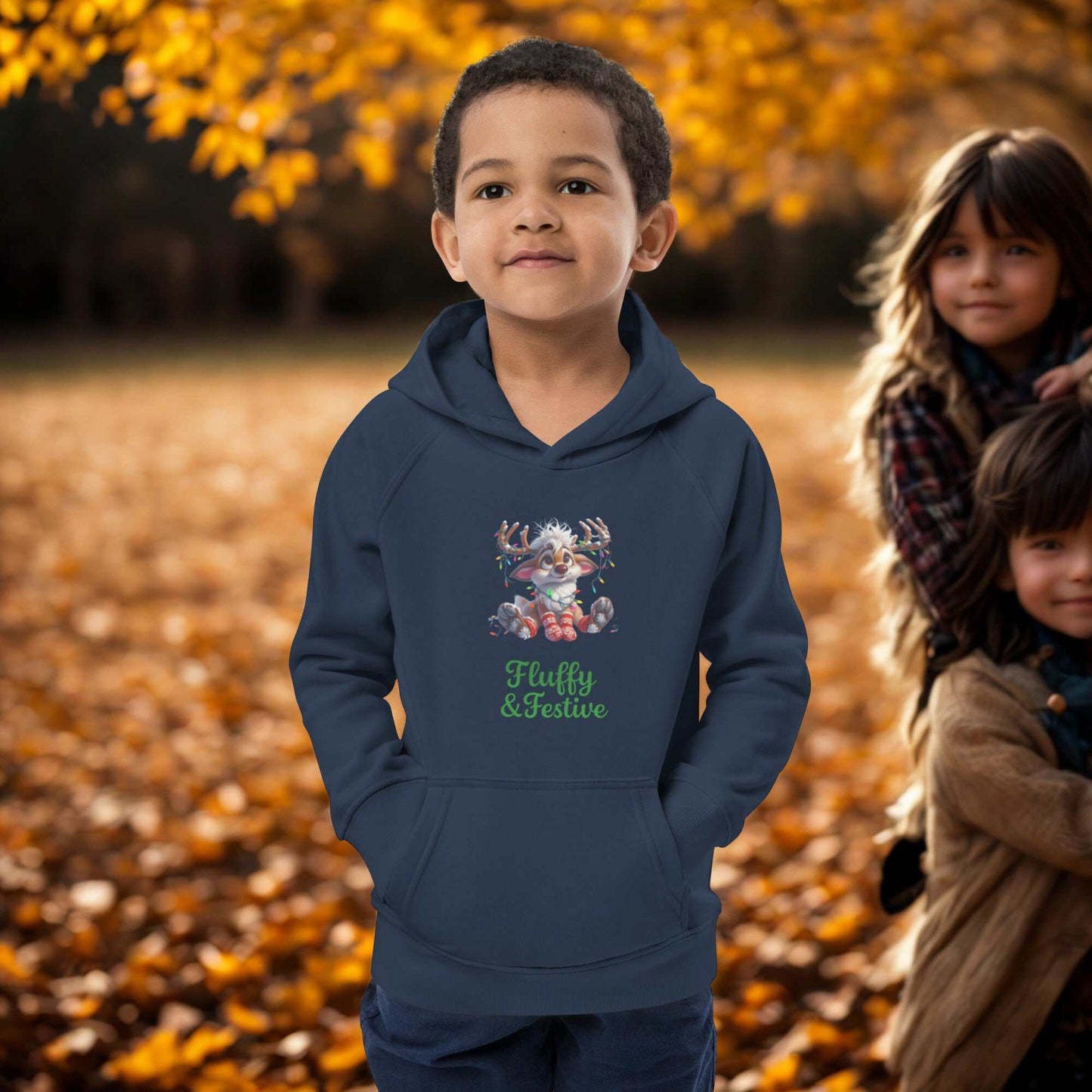 Child wearing navy blue kids Christmas hoodie with festive reindeer design outdoors in autumn setting