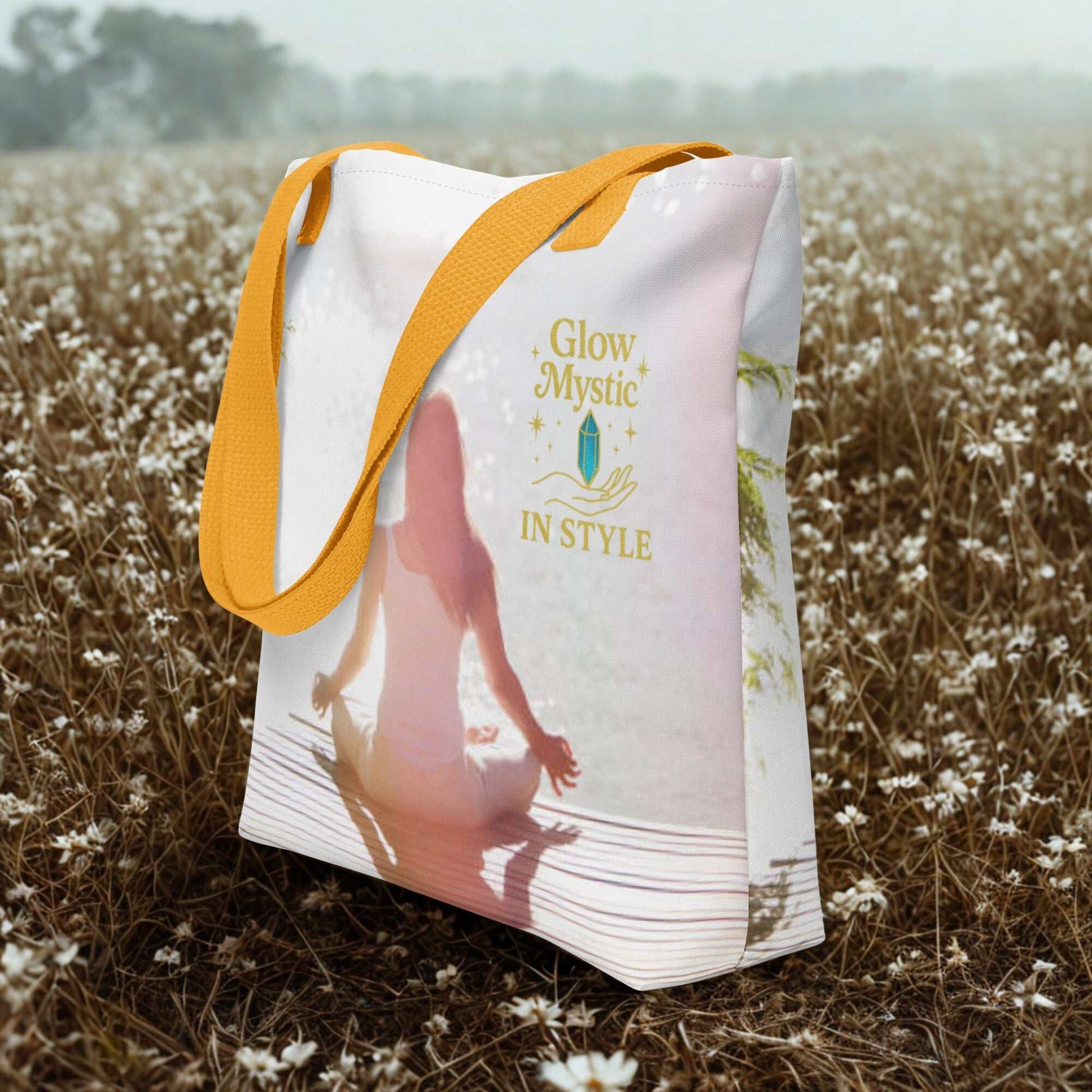 Spiritual Tote Bag with yellow handles featuring meditation design and Glow Mystic text in a field of flowers