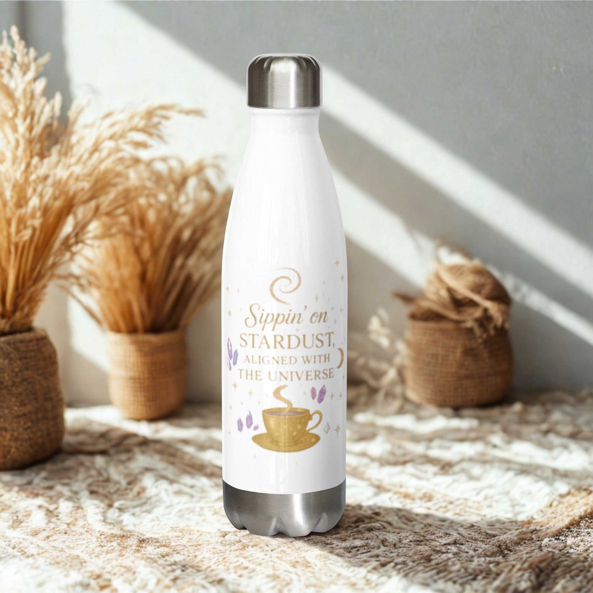 Sleek white Sippin on Stardust Water Bottle with gold and purple design, stainless steel insulated, 17 oz capacity, eco-friendly and leak-proof.