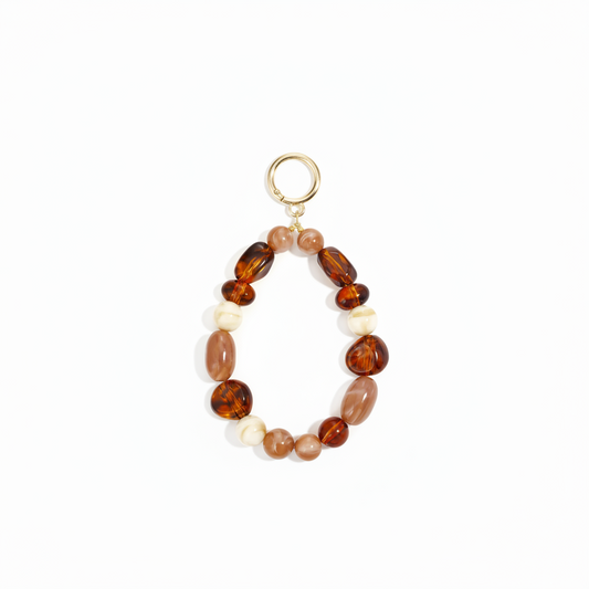 Luxe acryl telefoonkoord met beige en amberkleurige kralen voor smartphones.