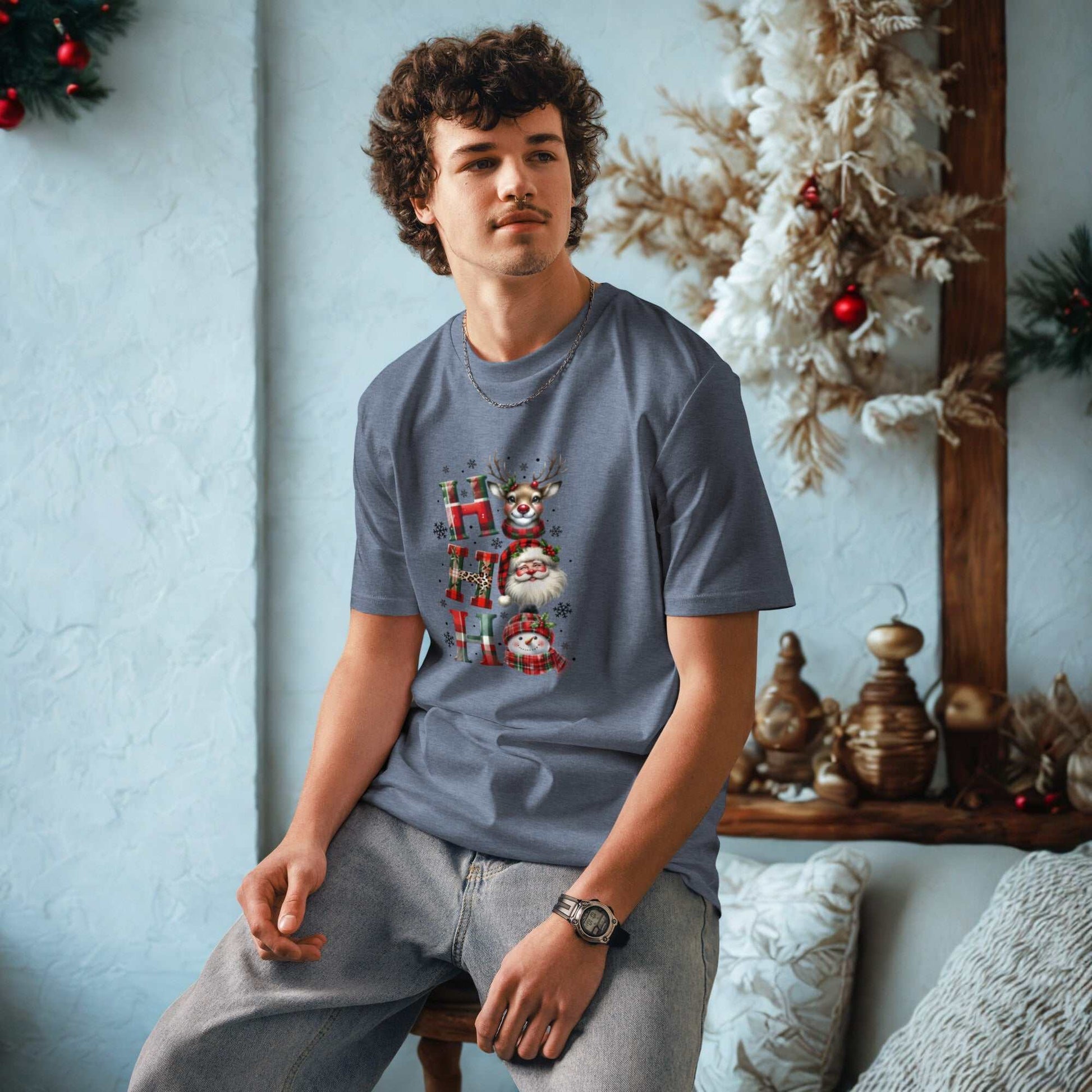 Man wearing unisex organic cotton Christmas t-shirt with festive holiday design sitting indoors near Christmas decorations