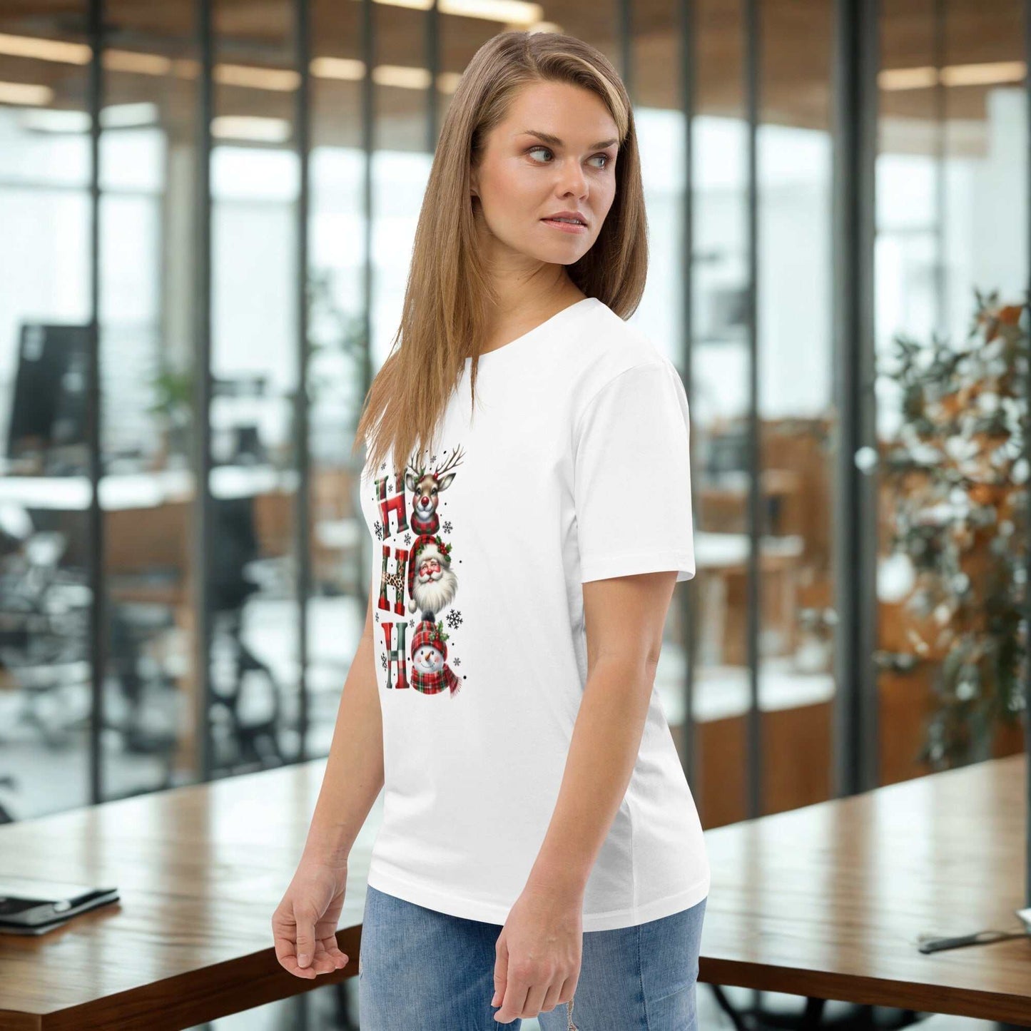 Woman wearing white unisex organic cotton Christmas T-shirt with festive reindeer and snowman design in modern office setting