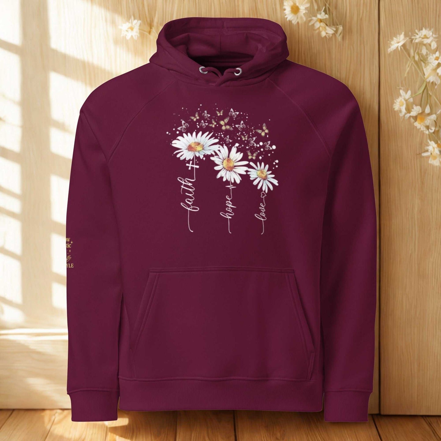 Unisex eco raglan hoodie in burgundy with floral print and inspiring text "faith hope love" made from organic and recycled materials