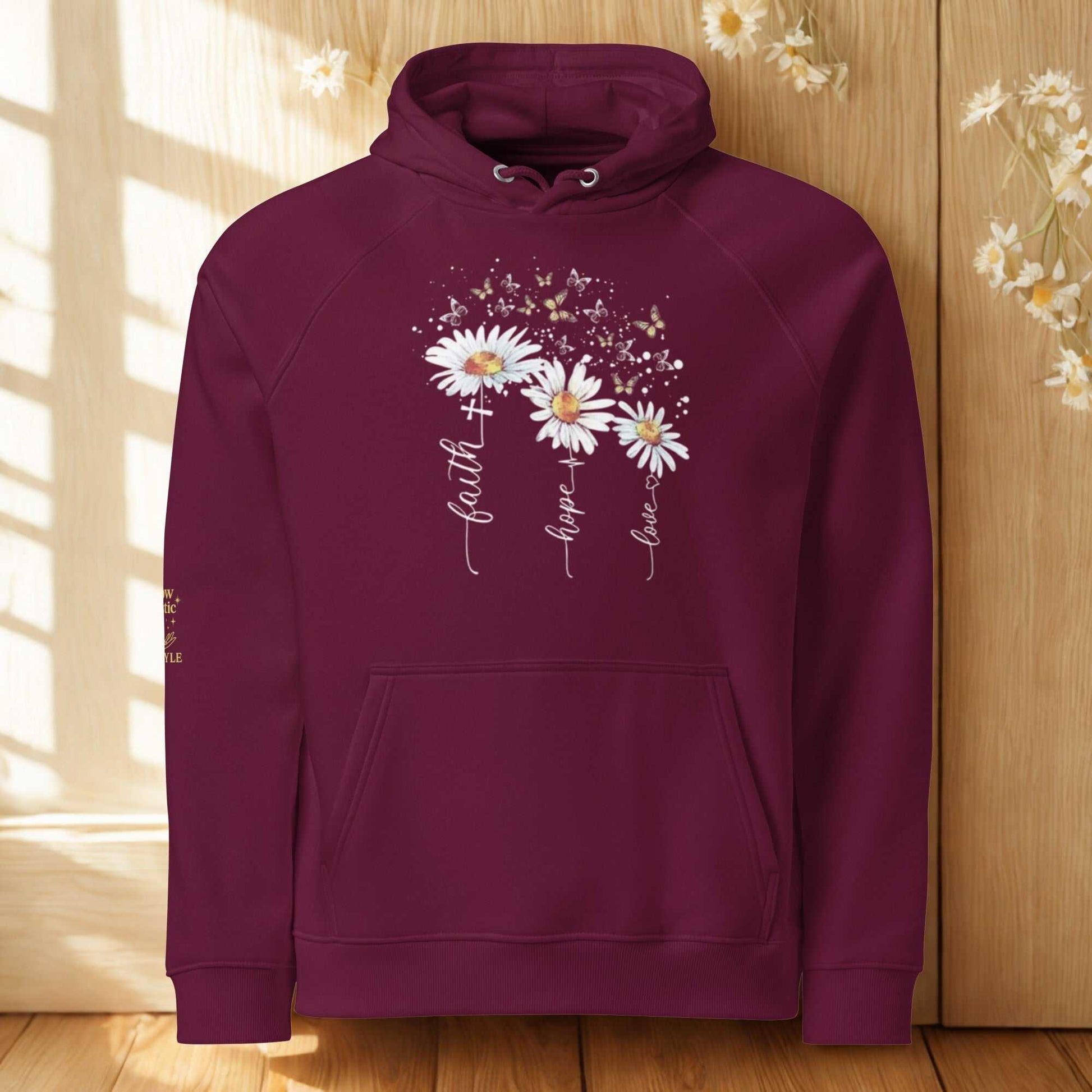 Unisex eco raglan hoodie in burgundy with floral print and inspiring text "faith hope love" made from organic and recycled materials