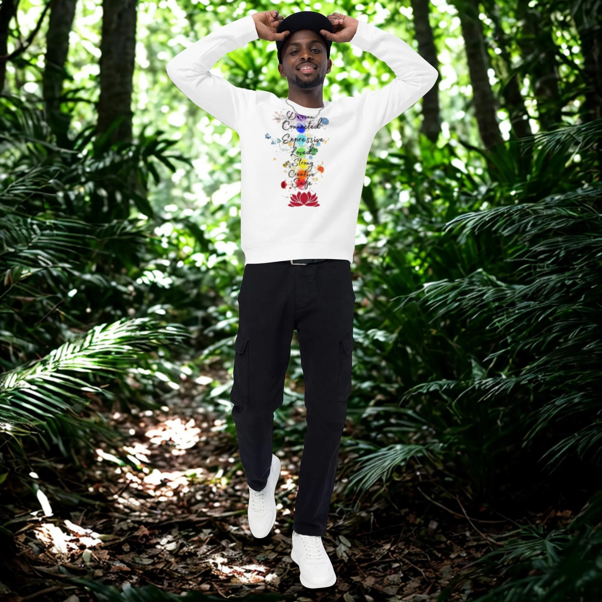 Man wearing white Unisex Organic Raglan Sweatshirt with colorful graphic design in forest background