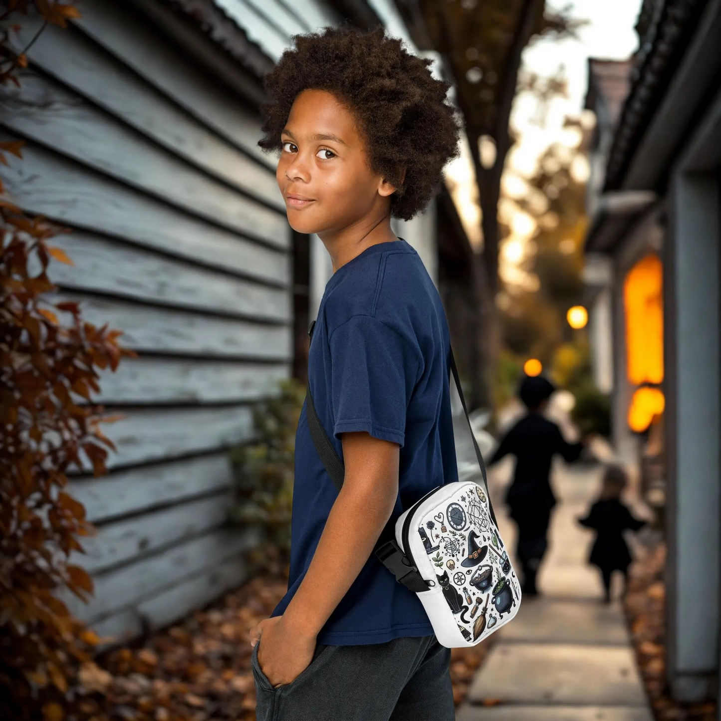 Child wearing a Witchy Halloween Crossbody Bag with festive witch-themed design outdoors