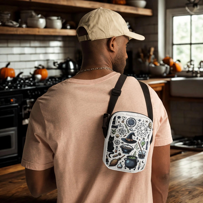 Man wearing Witchy Halloween crossbody bag with witch and Halloween motifs in kitchen setting