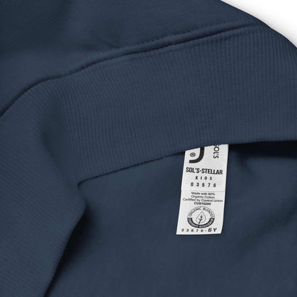 Close-up of navy blue Kids Christmas Hoodie fabric showing collar and care label with organic cotton certification