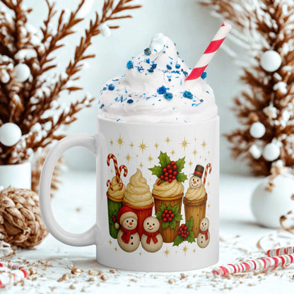 White glossy Christmas mug with festive holiday cupcake and snowman design filled with whipped cream and blue sprinkles