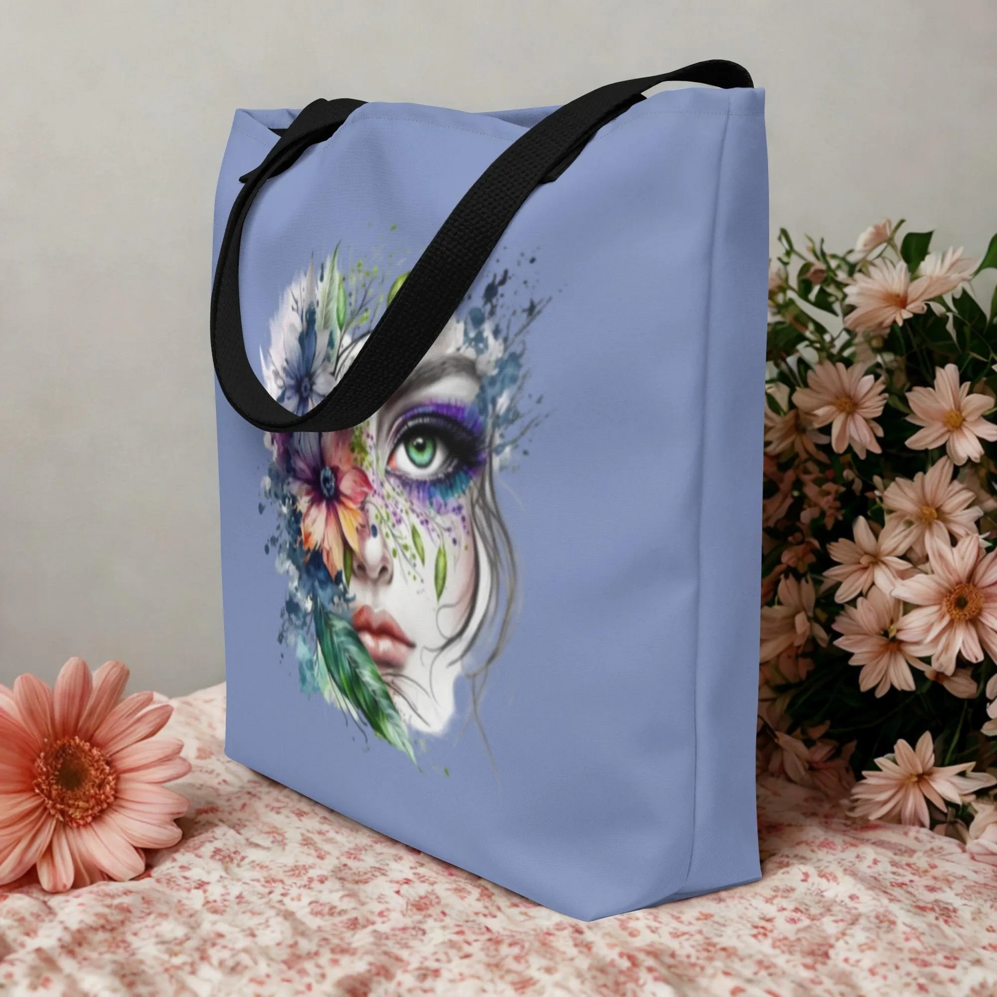 Large Floral Mystic Tote Bag with colorful artistic face and floral design on light blue background, durable with black handles, perfect for everyday use