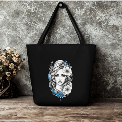 Black large tote bag featuring a mystical blue floral goddess design with white and blue flowers and black handles