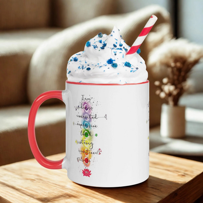 Motivation Chakra Mug ceramic white with red handle featuring chakra design and inspirational words filled with whipped cream and striped straw on wooden table