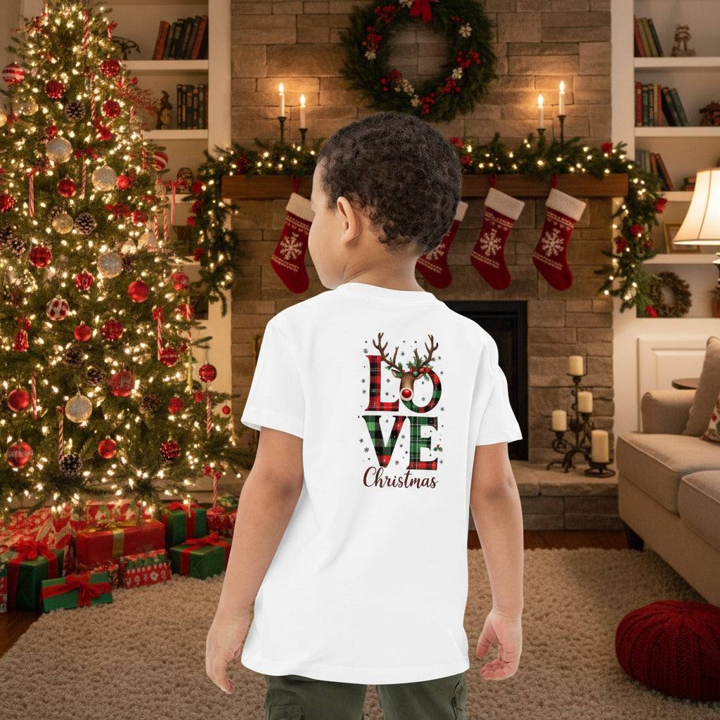 child wearing white organic kids t-shirt with festive Love Christmas design in cozy decorated living room