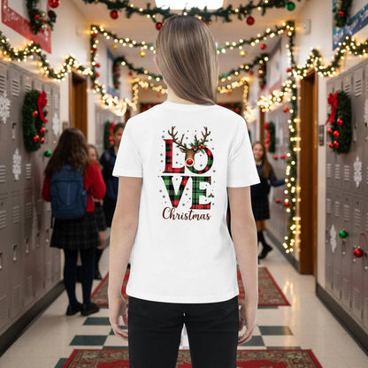 Child wearing white organic kids T-shirt with Love Christmas design in festive decorated school hallway