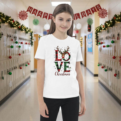 Child wearing white organic kids T-shirt with festive Love Christmas design in school hallway decorated for holidays