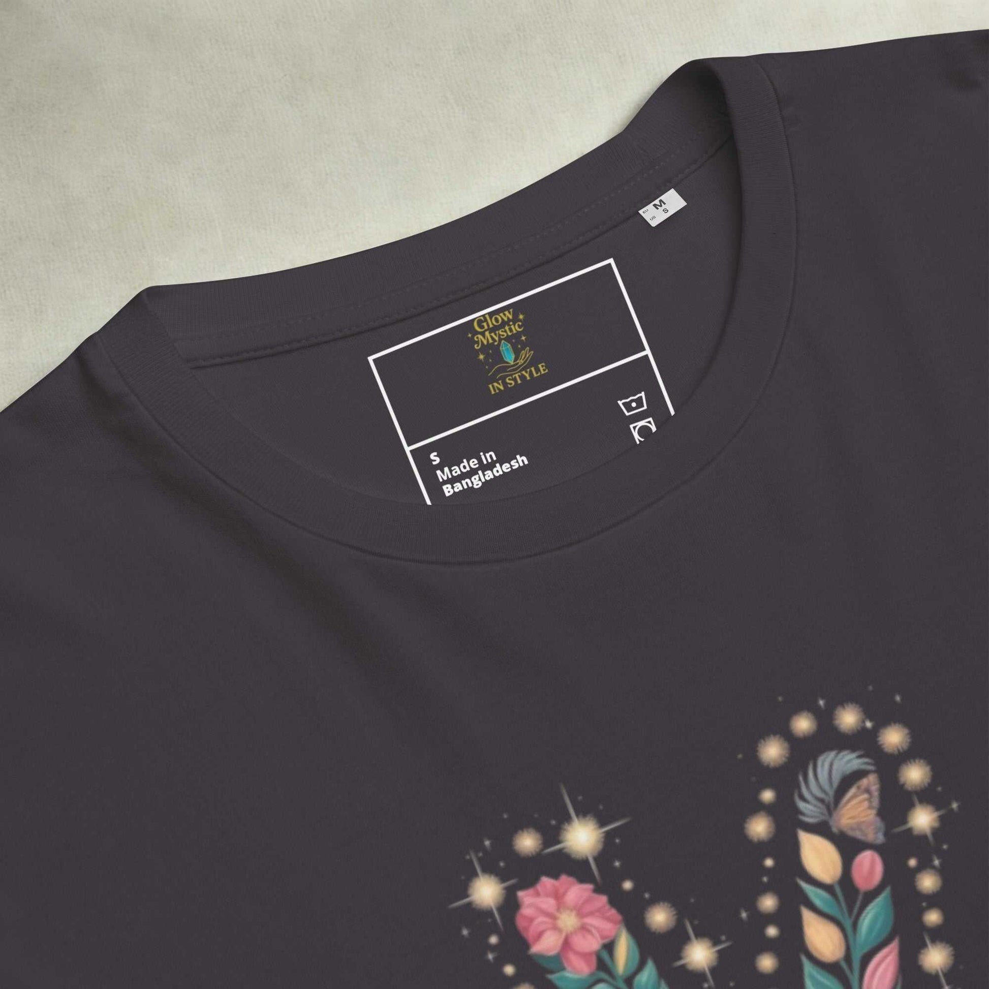 Black unisex organic cotton t-shirt with floral graphic design and crew neck