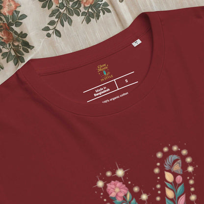 Close-up of a maroon unisex organic cotton t-shirt with floral design and printed label inside neckline