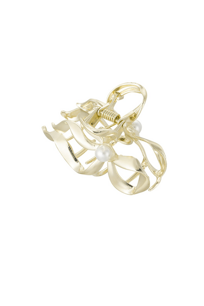 Zijaanzicht van de metalen strik haarklem met parel van het merk Glow Mystic in Style.