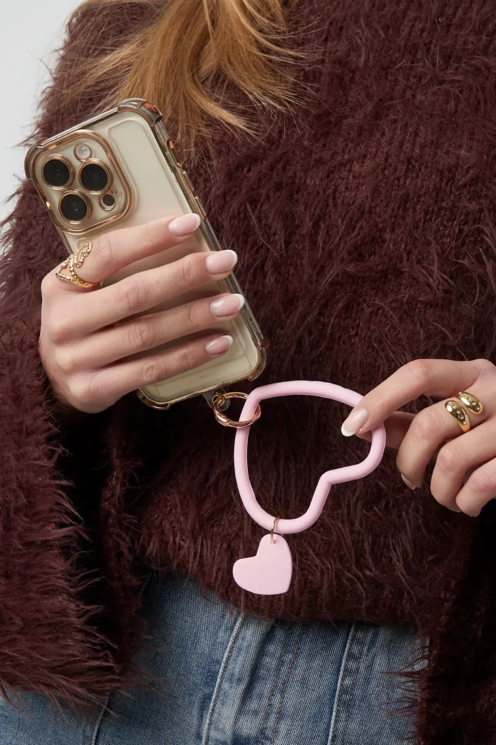 Glow Mystic in Style lichtroze siliconen hart telefoon polsband vastgehouden aan smartphone