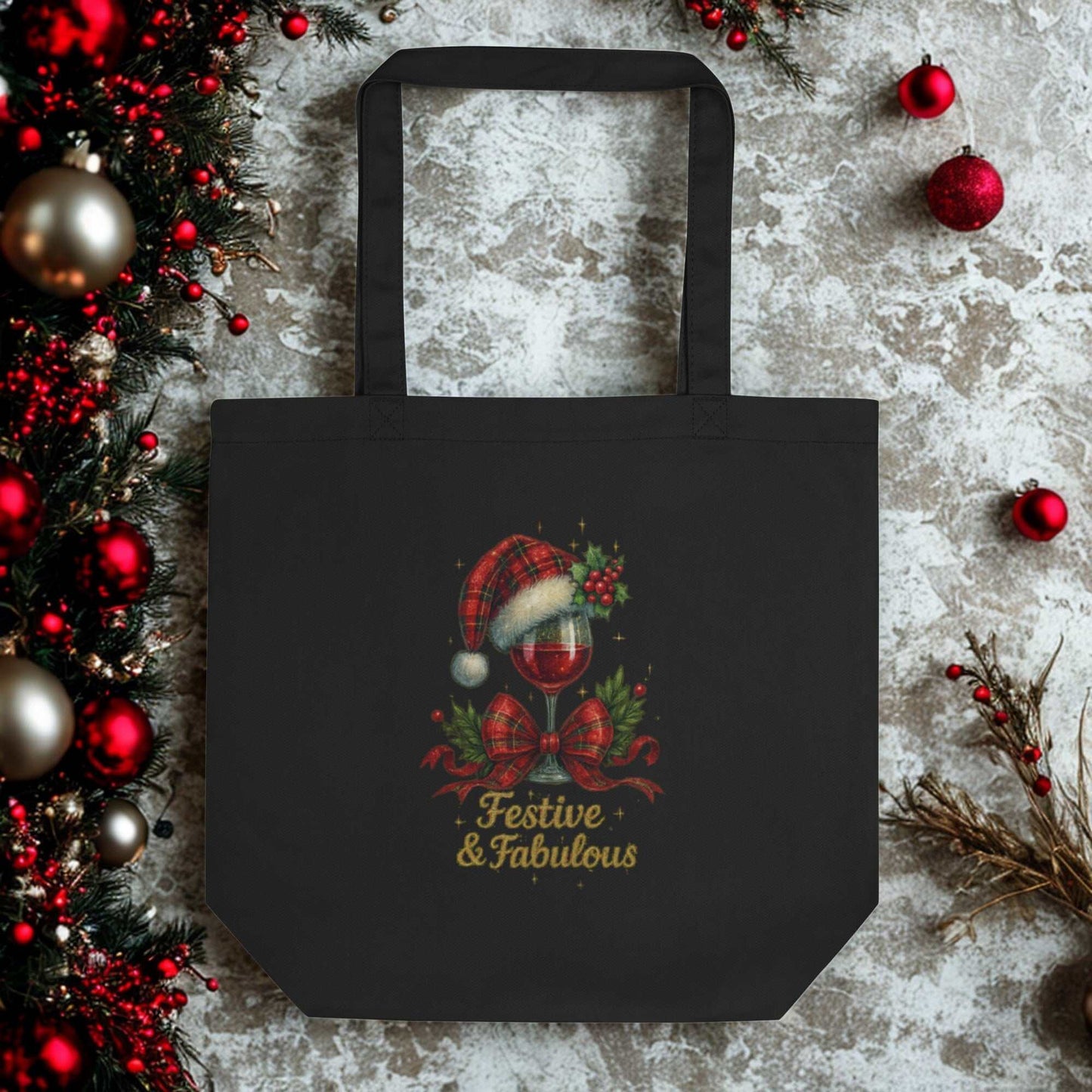 Black Eco Tote Bag with festive "Festive & Fabulous" holiday design featuring a Santa hat and holly decor, made of eco-friendly organic cotton