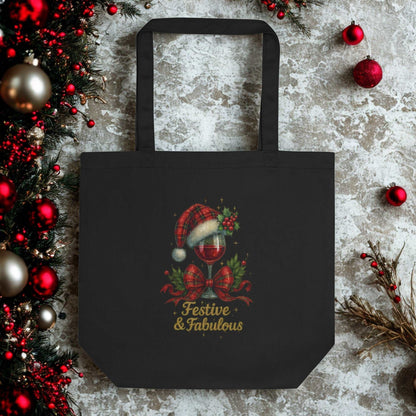 Black Eco Tote Bag with festive "Festive & Fabulous" holiday design featuring a Santa hat and holly decor, made of eco-friendly organic cotton