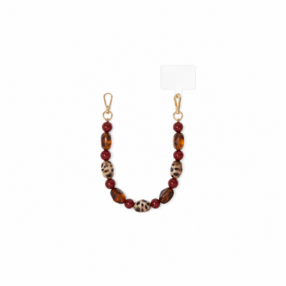 Glow Mystic in Style chunky schildpadprint en amber telefoonketting op witte achtergrond.