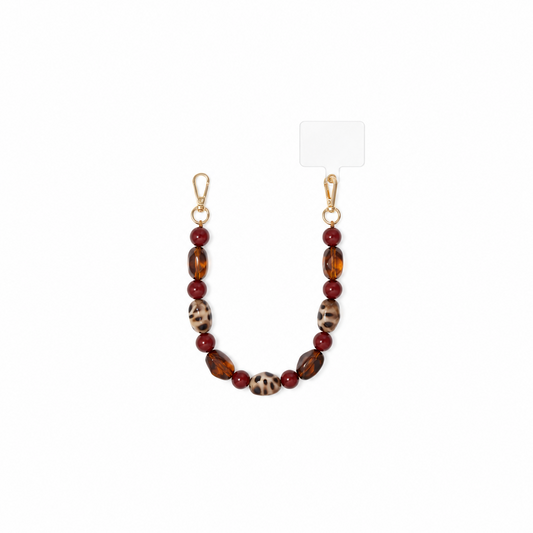 Glow Mystic in Style chunky schildpadprint en amber telefoonketting op witte achtergrond.