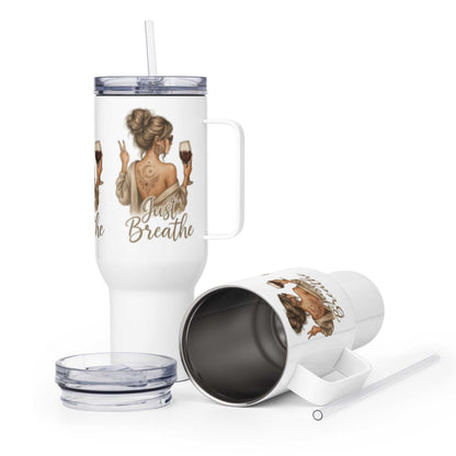 White travel mug with handle, "Just Breathe" text, and a woman holding a glass design, with lid and straw accessories.