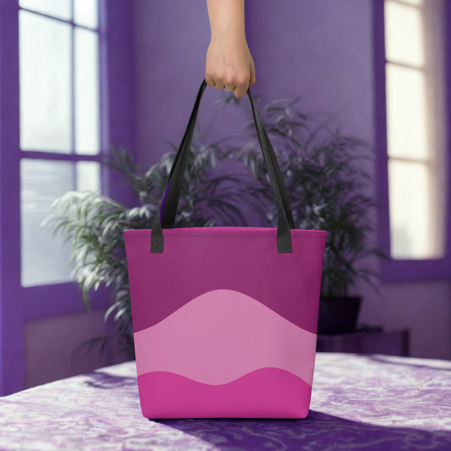 Mystic Butterfly Tote Bag with pink gradient design and black handles held indoors near plants