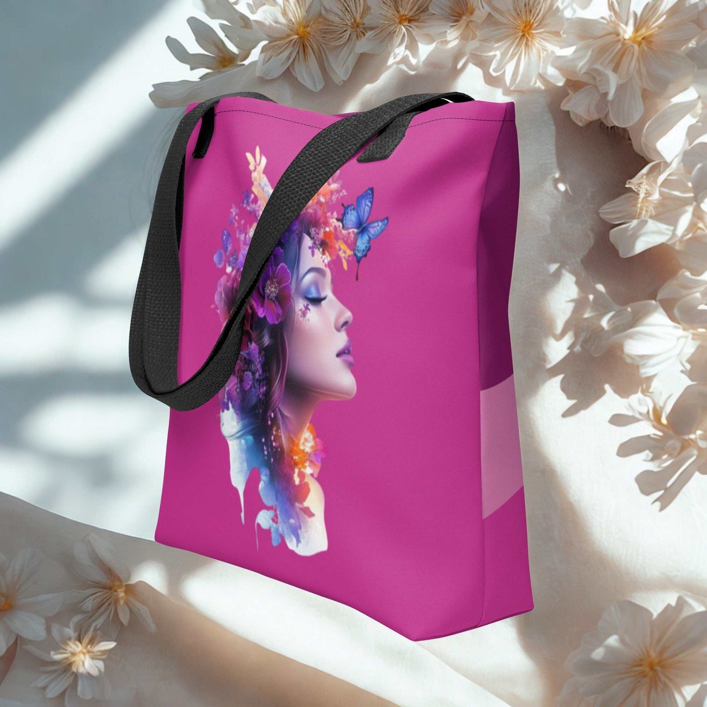Mystic Butterfly Tote Bag with colorful butterfly and floral woman design on pink background, black handles, eco-friendly reusable fabric.