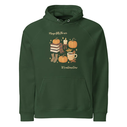 Green Magic Fills the Air Hoodie with autumn-themed illustrations including pumpkins, books, socks, and a candle